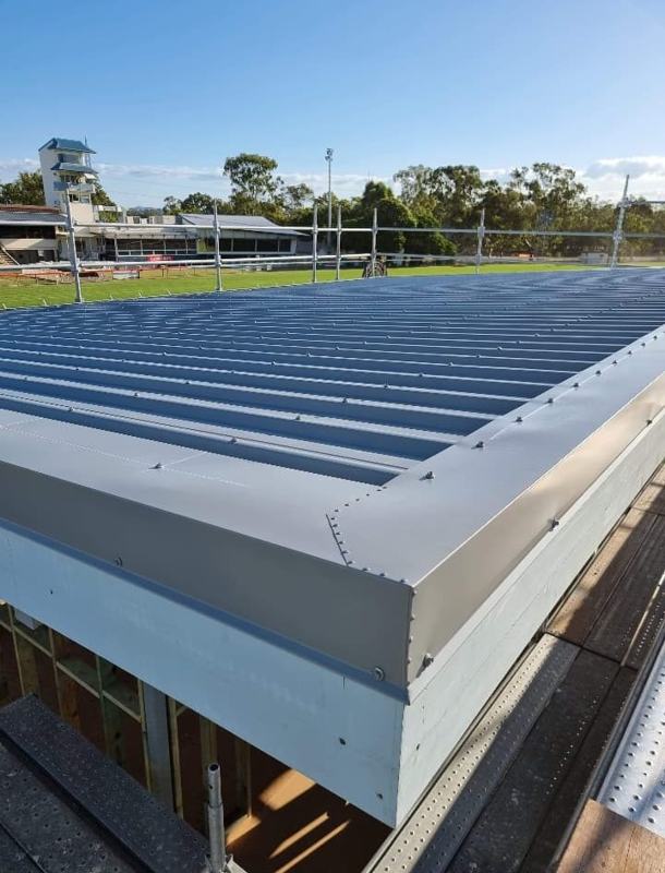 Edge of a new metal roof with fresh flashings